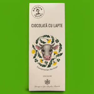 Răzvan Idicel 52% milk chocolate bar in white packaging with a cow illustration and Transylvanian heritage branding.